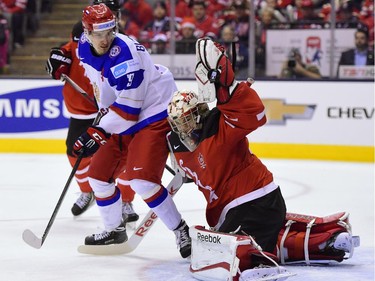 Russia's Pavel Buchnevich tries to get one past puck Canada goalie Zachary Fucale during first period gold medal game hockey action at the IIHF World Junior Championship in Toronto on Monday, Jan. 5, 2015.