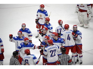 Russia's players wave goodbye to USA after a brief post-game skirmish in quarter-final hockey action at the IIHF World Junior Championship Friday, January 2, 2015 in Montreal. Russia won the game 3-2 to advance to the semifinals.