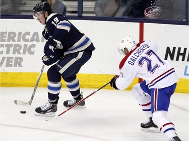 Columbus Blue Jackets' Ryan Johansen, left, controls the puck against Montreal Canadiens' Alex Galchenyuk during the third period of an NHL hockey game in Columbus, Ohio, Wednesday, Jan. 14, 2015. Montreal won 3-2.