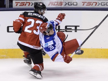 Team Russia's Sergei Tolchinski is dumped by Team Canada's Sam Reinhart during first period gold medal game hockey action at the IIHF World Junior Championship in Toronto on Monday, Jan. 5, 2015.