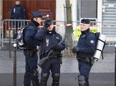 Security officers patrol Republique Square in Paris, Sunday, Jan. 11, 2015.  Thousands of people began filling France's iconic Republique plaza, and world leaders converged on Paris in a rally of defiance and sorrow on Sunday to honor the 17 victims of three days of bloodshed that left France on alert for more violence.