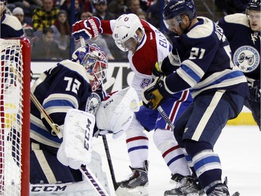 Columbus Blue Jackets goalie Sergei Bobrovosky (72), of Russia, stops a shot from Montreal Canadiens' Lars Eller (81), of Denmark, as Blue Jackets' James Wisniewski (21) looks on during the first period of an NHL hockey game in Columbus, Ohio, Wednesday, Jan. 14, 2015.