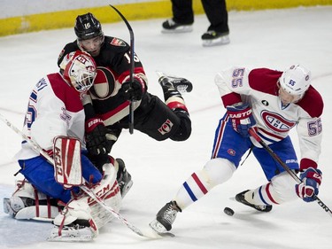 Ottawa Senators left wing Clarke MacArthur collides with Montreal Canadiens goalie Dustin Tokarski as Sergei Gonchar tries to control the puck during first- period action Thursday, Jan. 15, 2015, in Ottawa.