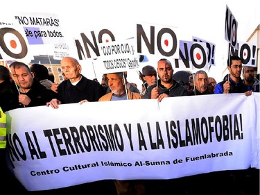 Muslims hold banners reading " No to terrorism and to Islamophobia " and "Islam = Peace"  in Madrid on January 11, 2015 during a show of solidarity following three days of bloodshed triggered by an attack on French satirical weekly Charlie Hebdo that left 12 dead. From London to Berlin via Washington and Montreal, rallies are organized throughout the weekend with the highlight in Paris where more than a million people and dozens of world leaders are expected to participate in a massive and historic march in Paris today in solidarity with the victims of the Islamist attacks that killed 17 and deeply shook the country.