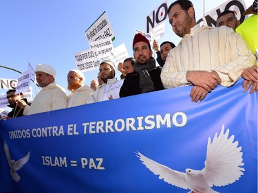 Muslim men hold a banner reading "United against terrorism"  in Madrid on January 11, 2015 during a show of solidarity following three days of bloodshed triggered by an attack on French satirical weekly Charlie Hebdo that left 12 dead. From London to Berlin via Washington and Montreal, rallies are organized throughout the weekend with the highlight in Paris where more than a million people and dozens of world leaders are expected to participate in a massive and historic march in Paris today in solidarity with the victims of the Islamist attacks that killed 17 and deeply shook the country.