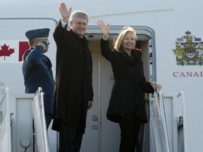 Canadian Prime Minister Stephen Harper and his wife Laureen board a government plane as they depart for China, Wednesday November 5, 2014 in Ottawa.