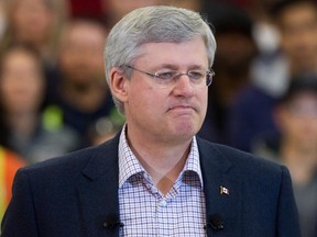 Prime Minister Stephen Harper pauses while speaking about the terrorist attack by masked gunmen in Paris, during an announcement at the British Columbia Institute of Technology Annacis Island Campus in Delta, B.C., on Thursday January 8, 2015.