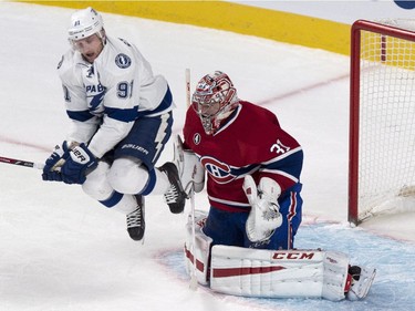 Tampa Bay Lightning's Steven Stamkos jumps to let a shot reach Montreal Canadiens goalie Carey Price during first period NHL hockey action Tuesday, January 6, 2015 in Montreal.