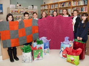 Students from the Genesis Elementary School Knitting Club display blankets they knitted to keep cancer patients warm during chemotherapy treatments at the Jewish General Hospital.