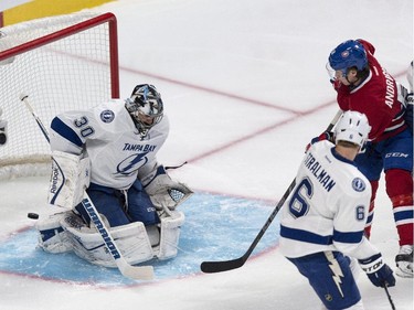 The puck flies shy of the goal line behind Tampa Bay Lightning goalie Ben Bishop on a shot by Montreal Canadiens' Sven Andrighetto during first period NHL hockey action Tuesday, January 6, 2015 in Montreal.