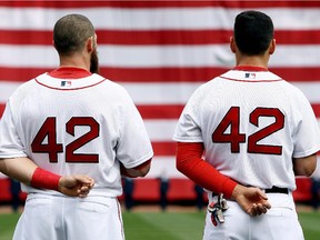 BOSTON, MA - APRIL 15: Jonny Gomes (L) and Jacoby Ellsbury (R) look on during the national anthem prior to a game against the Tampa Bay Rays at Fenway Park on April 15, 2013 in Boston, Massachusetts. All uniformed team members are wearing jersey number 42 in honor of Jackie Robinson Day.