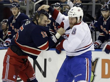 New York Rangers left wing Tanner Glass (15) and Montreal Canadiens right wing Brandon Prust (8) fight during the first period of the NHL hockey game Thursday, Jan. 29, 2015 at Madison Square Garden in New York.