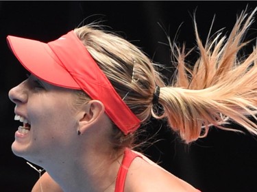 Russia's Maria Sharapova plays a shot during her women's singles match against Canada's Eugenie Bouchard on day nine of the 2015 Australian Open tennis tournament in Melbourne on January 27, 2015.