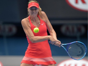 Russia's Maria Sharapova plays a shot during her women's singles match against Canada's Eugenie Bouchard on day nine of the 2015 Australian Open tennis tournament in Melbourne on January 27, 2015.