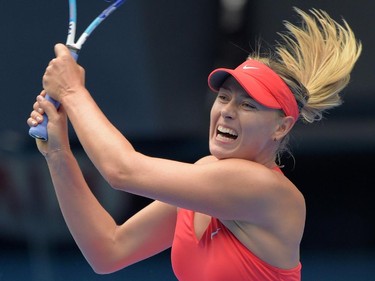Russia's Maria Sharapova plays a shot during her women's singles match against Canada's Eugenie Bouchard on day nine of the 2015 Australian Open tennis tournament in Melbourne on January 27, 2015.