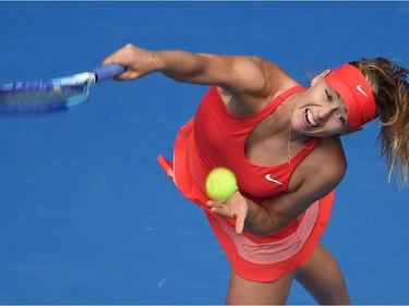 Russia's Maria Sharapova serves during her women's singles match against Canada's Eugenie Bouchard on day nine of the 2015 Australian Open tennis tournament in Melbourne on January 27, 2015.