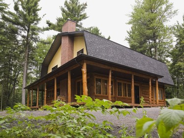 The exterior finish of the home is a fusion of the rustic look with conventional clapboard siding and asphalt shingles roofing materials.