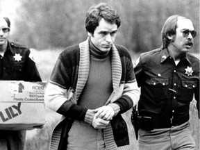 Convicted kidnapper Theodore Bundy is led into the Pitkin County courthouse by Deputy Peter Murphy, left, and Rick Kralicek for a hearing in Aspen, Colo., on June 8, 1977.  Bundy, who was being charged for murder, jumped out of a second-story window during a court recess.