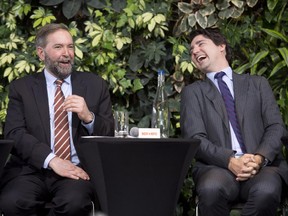 Liberal Leader Justin Trudeau laughs with NDP Leader Tom Mulcair as he speaks during a panel discussion on youth voting, Wednesday, March 26, 2014 in Ottawa. A CROP survey for La Presse published today suggests the NDP and Mulcair have pulled far ahead of Trudeau and the Liberals in Quebec.