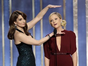 Tina Fey, left, and Amy Poehler host the Golden Globes again on Sunday.