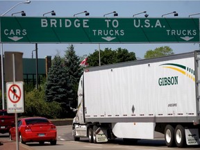 Traffic makes its way to Ambassador Bridge that connects Canada to the United States Windsor Ont. on Friday June 15, 2012. A proposal to charge travellers a new fee when entering the U.S. at land border crossings has drawn condemnation in both countries.