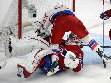 Washington Capitals right wing Troy Brouwer (20) runs into Montreal Canadiens goalie Carey Price (31) during second period National Hockey League action in Montreal on Saturday, January 31, 2015.