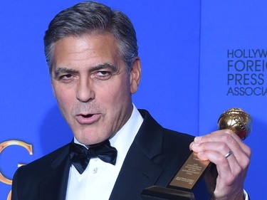 George Clooney poses with the Cecil B. DeMille Award, in the press room at the 72nd annual Golden Globe Awards, January 11, 2015 at the Beverly Hilton Hotel in Beverly Hills, California.