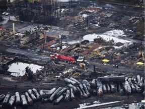 Workers comb through debris after a train derailed Saturday, July 9, 2013 causing explosions of railway cars carrying crude oil in Lac-Megantic, Que. The funds earmarked for those affected by the Lac-Megantic train disaster represent just a fraction of what's needed, a town official says.