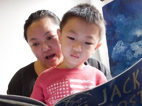 Xuan Pan reads with her son Charlie Gao at the Montreal Children's Library in Montreal Saturday, January 24, 2015.