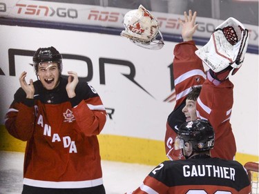 Team Canada goaltender Zachary Fucale and teammate Shea Theodore, left, celebrate their gold medal victory over Team Russia at the IIHF World Junior Championship in Toronto on Monday, Jan. 5, 2015.