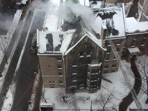 Firefighters work on putting out a fire at Royal Victoria College in Montreal.