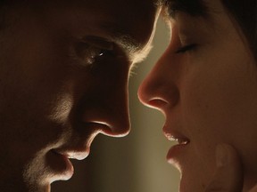 In this image released by Universal Pictures and Focus Features, Jamie Dornan, left, and Dakota Johnson appear in a scene from Fifty Shades of Grey.