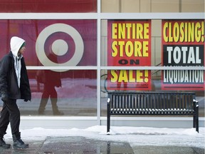 A shopper walks past sale signs at a Target store.