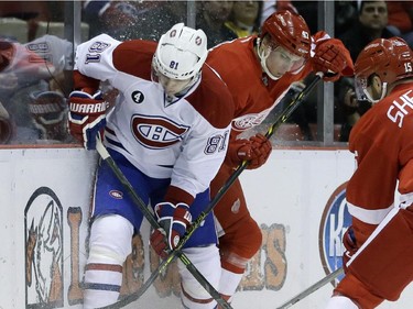 Montreal Canadiens centre Lars Eller (81) and Detroit Red Wings defenceman Alexei Marchenko (47), of Russia, battle for the puck during the first period of an NHL hockey game Monday, Feb. 16, 2015, in Detroit.