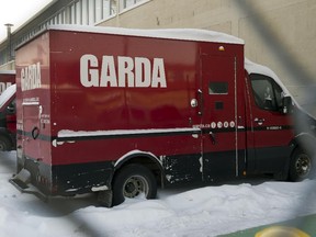 An armoured truck sits in the parking lot at GardaWorld company headquarters Wednesday, Dec.18, 2013 in Montreal.