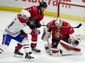 Ottawa Senators defenceman Jared Cowen ties up Montreal Canadiens centre Lars Eller as goalie Andrew Hammond makes a save during first period NHL action Wednesday February 18, 2015 in Ottawa.