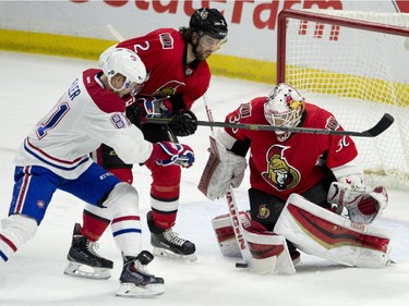 Ottawa Senators defenceman Jared Cowen ties up Montreal Canadiens centre Lars Eller as goalie Andrew Hammond makes a save during first period NHL action Wednesday February 18, 2015 in Ottawa.