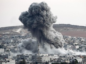 Heavy smoke rises following an airstrike by the US-led coalition aircraft in Kobani, Syria, during fighting between Syrian Kurds and the militants of Islamic State group, as seen from the outskirts of Suruc, on the Turkey-Syria border, October 18, 2014.  Kurdish fighters in Syrian city of Kobani have pushed back Islamic State militants in a number of locations as U.S. airstrikes on ISIS positions continue in and around the city. Since mid-September more than 200,000 people from Kobani flee into Turkey.