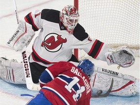 New Jersey Devils goaltender Keith Kinkaid makes a save on Montreal Canadiens' Brendan Gallagher during second period NHL hockey action in Montreal, Saturday, February 7, 2015.