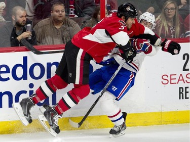 Ottawa Senators defenceman Marc Methot collides with Montreal Canadiens right wing Brendan Gallagher along the boards during second period NHL action Wednesday February 18, 2015 in Ottawa.