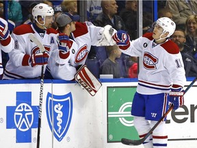 Montreal Canadiens' Brendan Gallagher, right, is congratulated by teammates after scoring a goal against the St. Louis Blues during the second period of an NHL hockey game Tuesday, Feb. 24, 2015, in St. Louis.