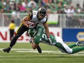 Craig Butler tackles Hamilton Tiger-Cats receiver Samuel Giguère during CFL game at Mosaic Stadium in Regina on Sept.  21, 2013.