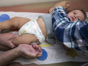 In this Thursday, Jan. 29, 2015, photo, pediatrician Charles Goodman vaccinates 1-year-old Cameron Fierro with the measles-mumps-rubella vaccine, or MMR vaccine, at his practice in Northridge, Calif. The largest measles outbreak in recent memory occurred in Ohio's Amish country where 383 people were sickened last year after several traveled to the Philippines and brought the virus home. While that outbreak got the public's attention, it's nowhere near the level as the latest measles outbreak that originated at Disneyland in December, prompting politicians to weigh in and parents to voice their vaccinations views on Internet message boards.