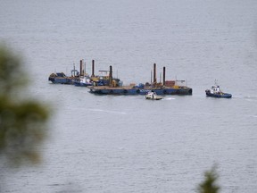 In this September 23, 2014 photo shows two barges conduct seismic tests in the St-Lawrence river in Cacouna, in order to build an oil terminal for TransCanada that would start operating in 2018. The Canadian company wants to build the East-Energy pipeline, a mega-pipeline that will carry crude oil from Alberta, to Cacouna.