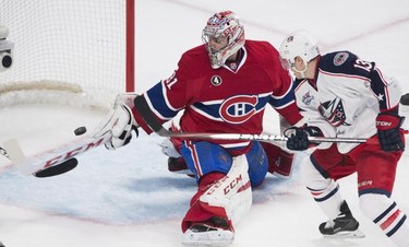 Montreal Canadiens goaltender Carey Price makes a save on Columbus Blue Jackets' Cam Atkinson during second period NHL hockey action in Montreal, Saturday, February 21, 2015.