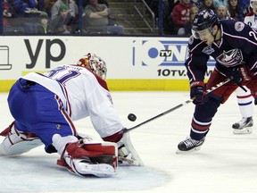 Montreal Canadiens' Carey Price, left, makes a save against Columbus Blue Jackets' Corey Tropp during the second period of an NHL hockey game Thursday, Feb. 26, 2015, in Columbus, Ohio.