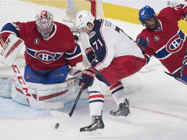 Montreal Canadiens goaltender Carey Price makes a save on Columbus Blue Jackets' Nick Foligno (71) as Canadiens' P.K. Subban defends during third period NHL hockey action in Montreal, Saturday, February 21, 2015.