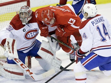 Detroit Red Wings centre Pavel Datsyuk (13), of Russia, is tripped in front of Montreal Canadiens goalie Carey Price (31) during the third period of an NHL hockey game, Monday, Feb. 16, 2015 in Detroit. Montreal won 2-0.