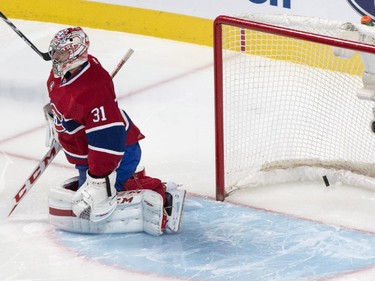 The puck sails into the net behind Montreal Canadiens goalie Carey Price on a goal by Philadelphia Flyers' Matt Read during first period NHL hockey action Tuesday, February 10, 2015 in Montreal.