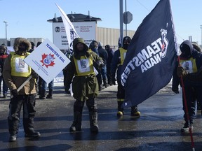 Canadian Pacific Railway workers walk the picket line while on strike at the Côte St-Luc railyard in Montreal on Monday, Feb. 16, 2015. The rail workers, represented by the Teamsters, walked off the job Sunday morning after contract talks failed to produce an agreement.   On Monday afternoon, federal Labour Minister Kellie Leitch said the strike is over, with both sides agreeing to resume discussions.
News of the deal comes with the government poised to introduce back-to-work legislation and the Commons debating a speedy process to pass it.